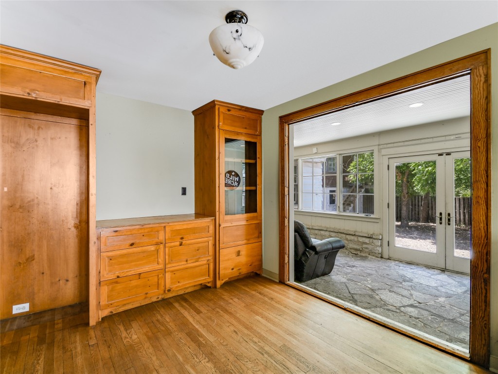 2304 Longview Street Austin, TX 78705 - Photo 9 of 31 a view of an empty room with a fireplace and wooden floor