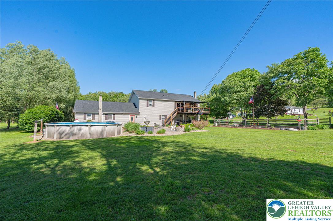 341 Lower Greenhill Road Kunkletown, PA 18058 - Photo 60 of 69 A spacious backyard retreat featuring an above-ground pool, expansive green lawn, and a multi-level deck for outdoor enjoyment.