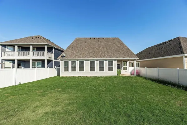 a view of an house with backyard space and balcony