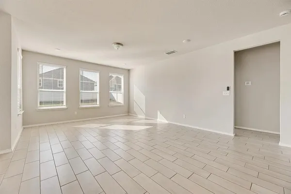 a view of an empty room with windows