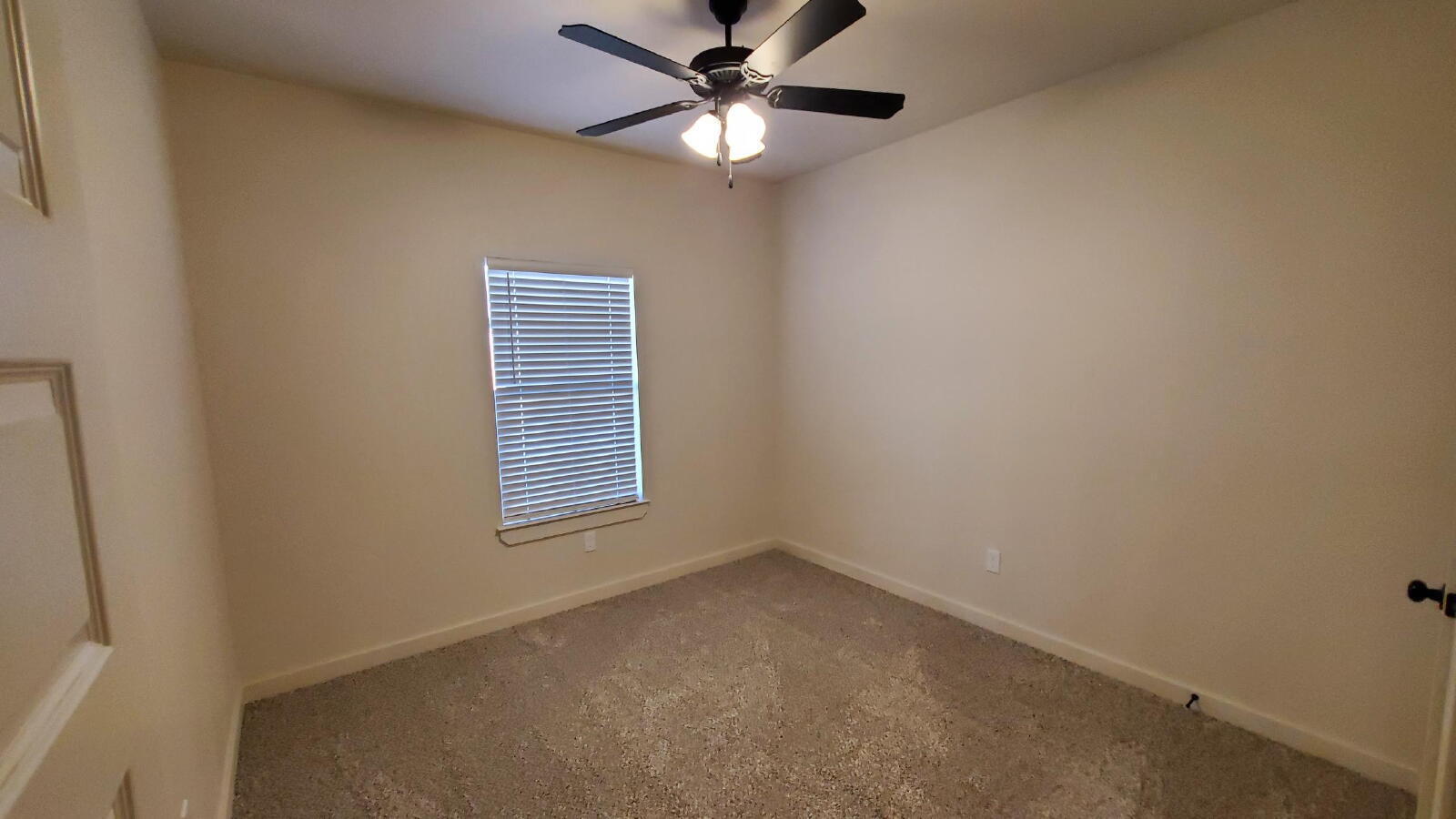 1230 North 7th Street Wolfforth, TX 79382 - Photo 9 of 16 a view of a room with windows and ceiling fan