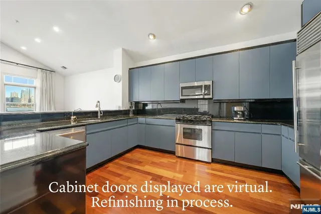 a kitchen with a sink and stainless steel appliances