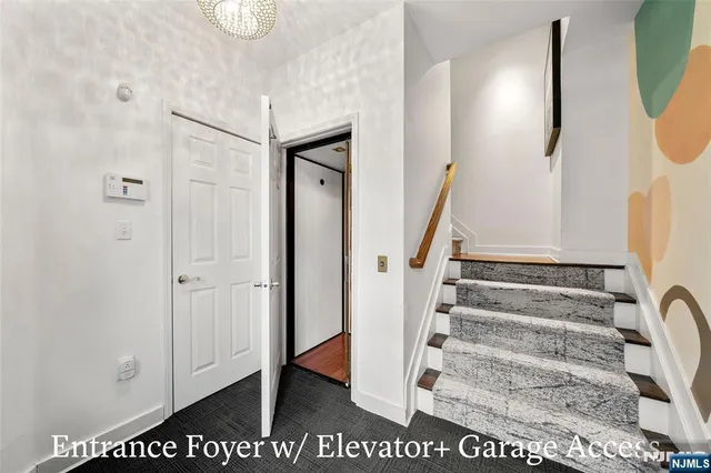 a view of entryway with furniture and wooden floor