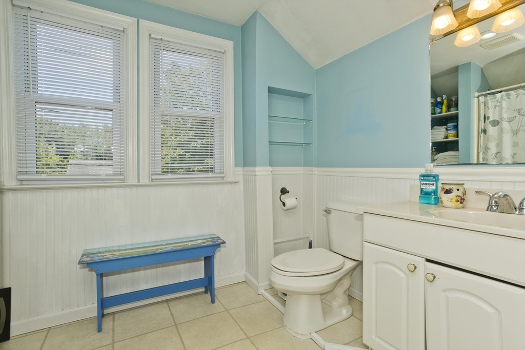 103 Hillcrest Avenue West Springfield, MA 01089 - Photo 19 of 28 a bathroom with a toilet a sink a mirror and a window