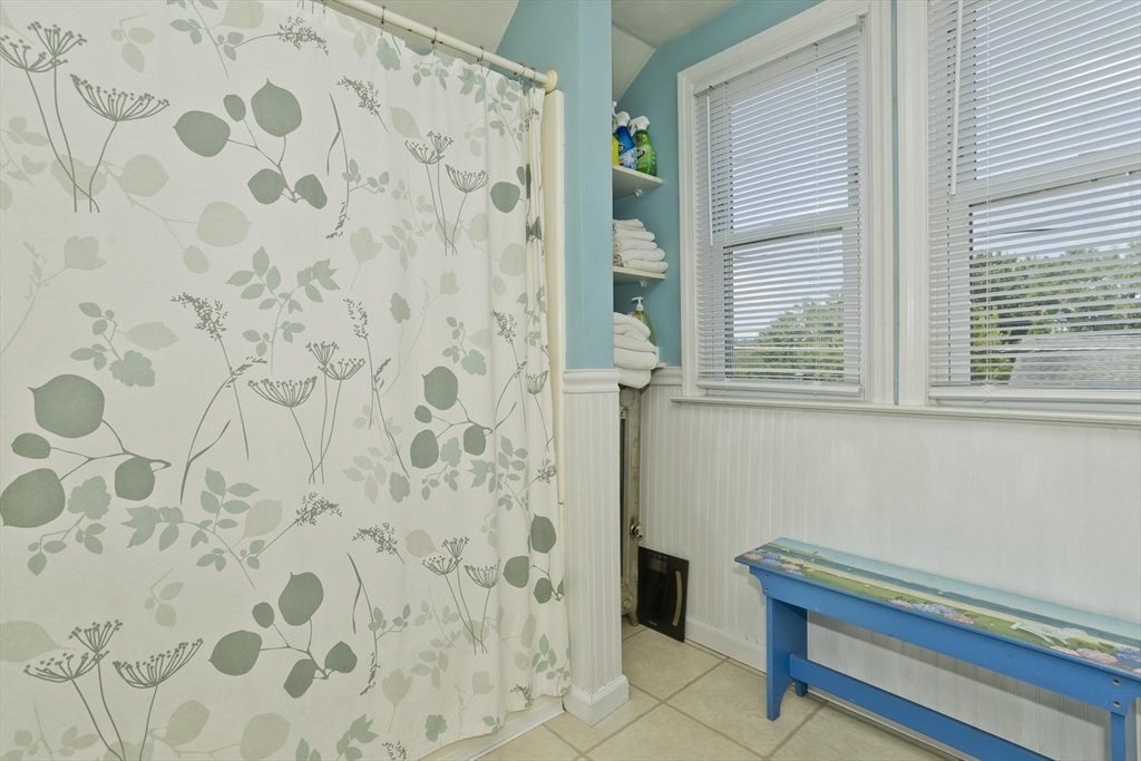 103 Hillcrest Avenue West Springfield, MA 01089 - Photo 20 of 28 a bathroom with a window and a shower curtain