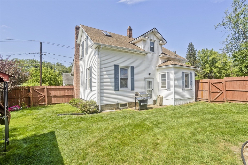 103 Hillcrest Avenue West Springfield, MA 01089 - Photo 24 of 28 a big white house with a small yard and more windows