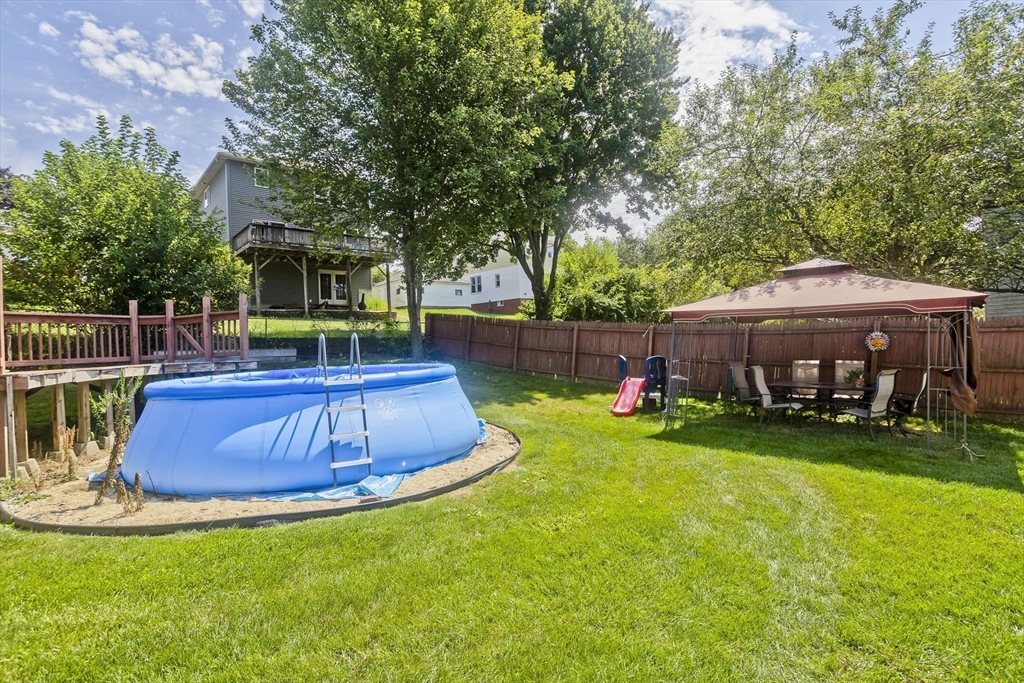 103 Hillcrest Avenue West Springfield, MA 01089 - Photo 26 of 28 a view of a backyard with table and chairs potted plants and large tree