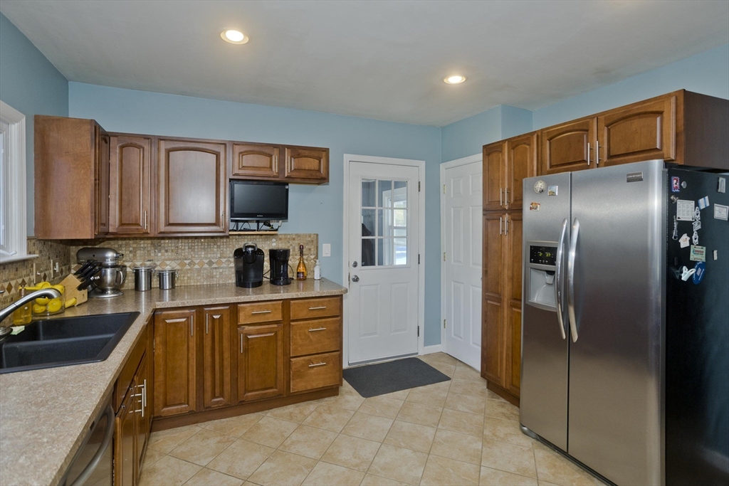 103 Hillcrest Avenue West Springfield, MA 01089 - Photo 3 of 28 a kitchen with stainless steel appliances granite countertop a refrigerator and a sink