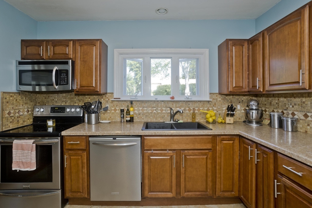 103 Hillcrest Avenue West Springfield, MA 01089 - Photo 5 of 28 a kitchen with stainless steel appliances granite countertop a sink stove and cabinets