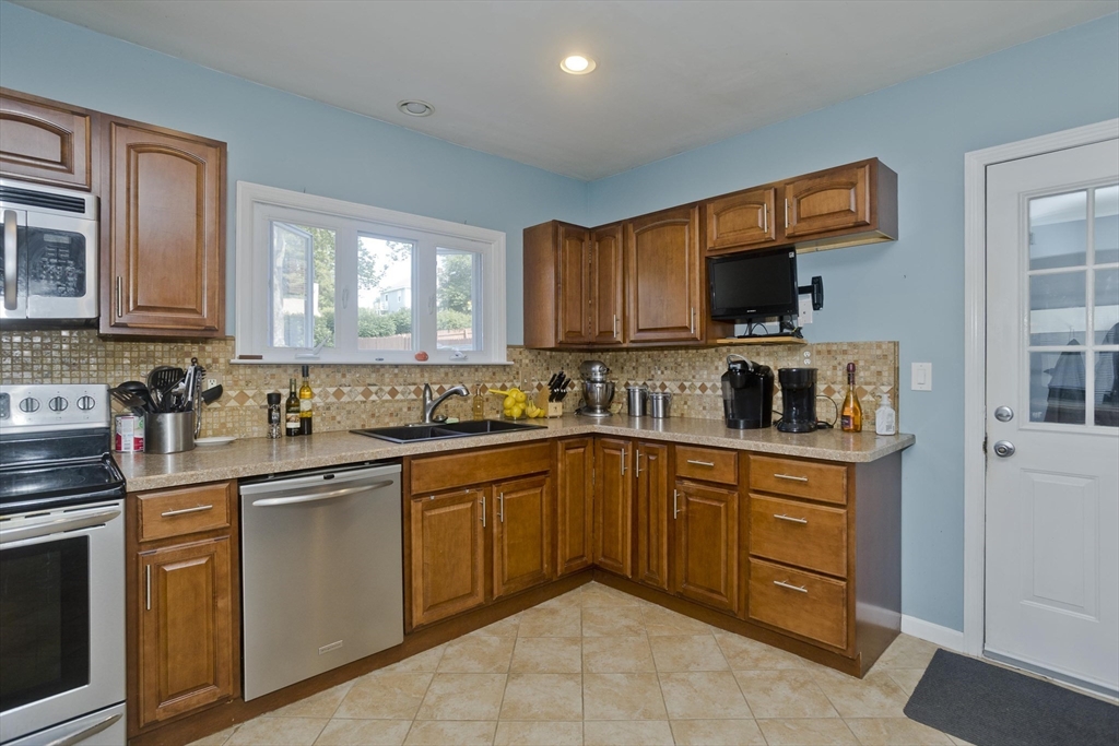 103 Hillcrest Avenue West Springfield, MA 01089 - Photo 7 of 28 a kitchen with stainless steel appliances granite countertop a sink and cabinets