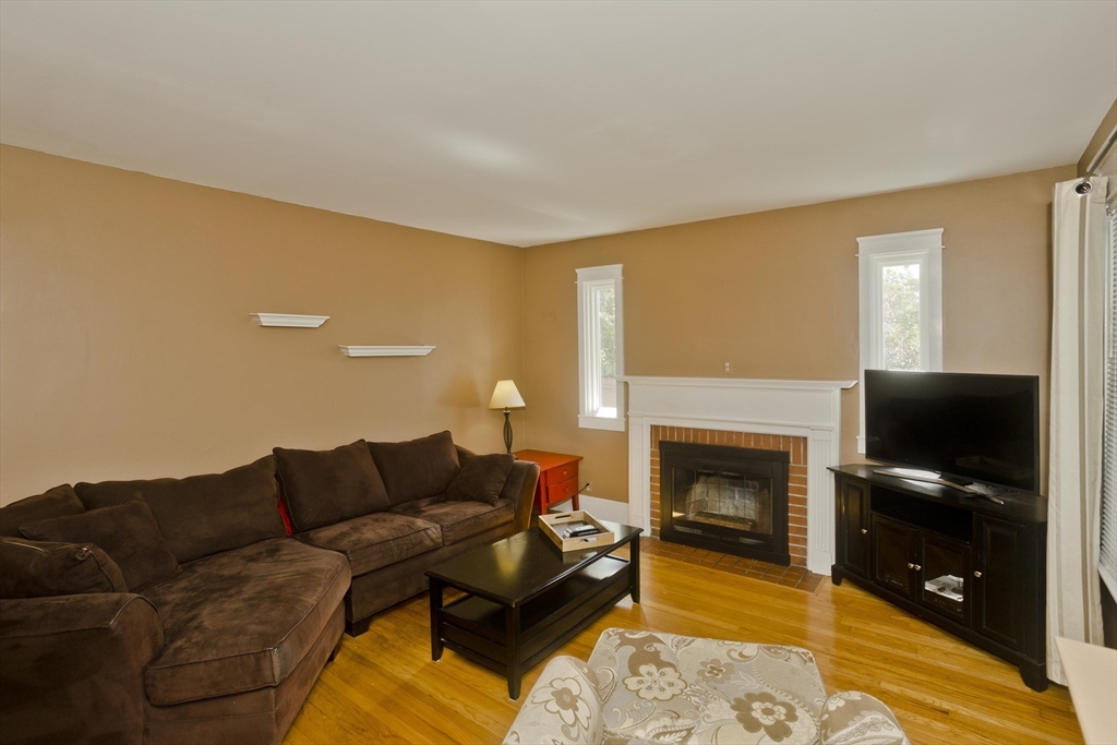 103 Hillcrest Avenue West Springfield, MA 01089 - Photo 9 of 28 a living room with furniture a flat screen tv and a fireplace