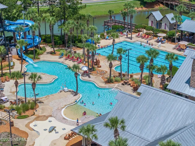 a view of an empty room with window and a kitchen view