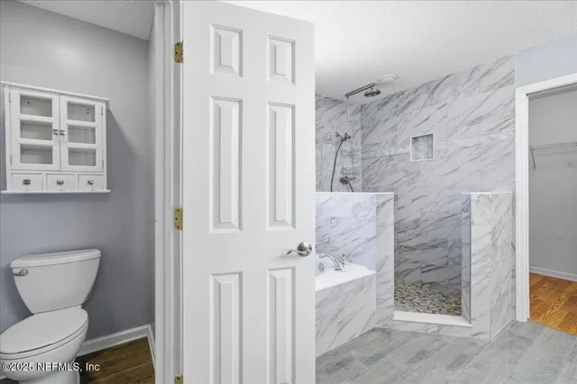 a view of a park with a bench and trees