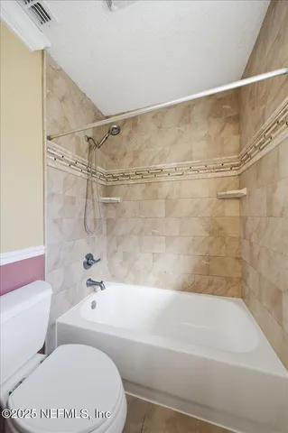 an aerial view of a house with a swimming pool and outdoor seating