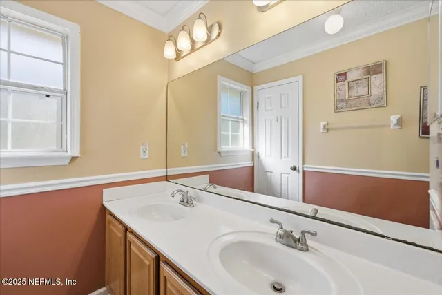 an aerial view of residential house with outdoor space and trees all around