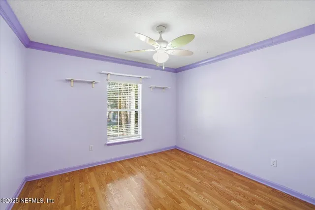 an aerial view of a house with a yard and lake view