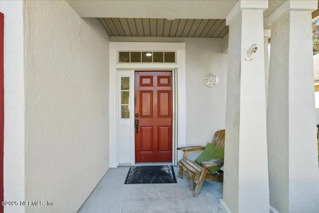 a view of a living room with wooden floor and a ceiling fan