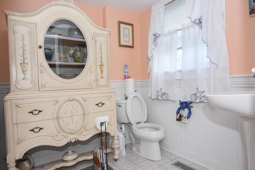 8 East Boulevard Wareham, MA 02558 - Photo 11 of 39 a bathroom with a toilet a sink and a mirror