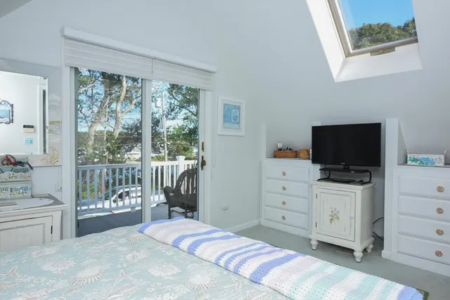 a bedroom with a bed and large window