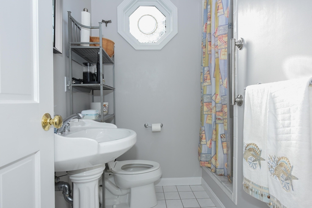 8 East Boulevard Wareham, MA 02558 - Photo 15 of 39 a bathroom with a sink a toilet and shower