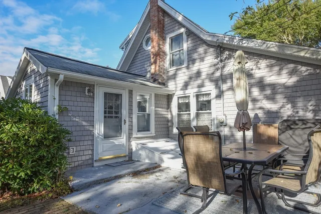 a view of a house with a small yard and wooden fence