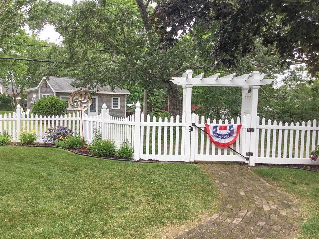 8 East Boulevard Wareham, MA 02558 - Photo 31 of 39 a view of a house with a small yard and wooden fence