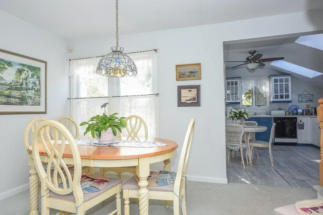 a view of a dining room with furniture and chandelier