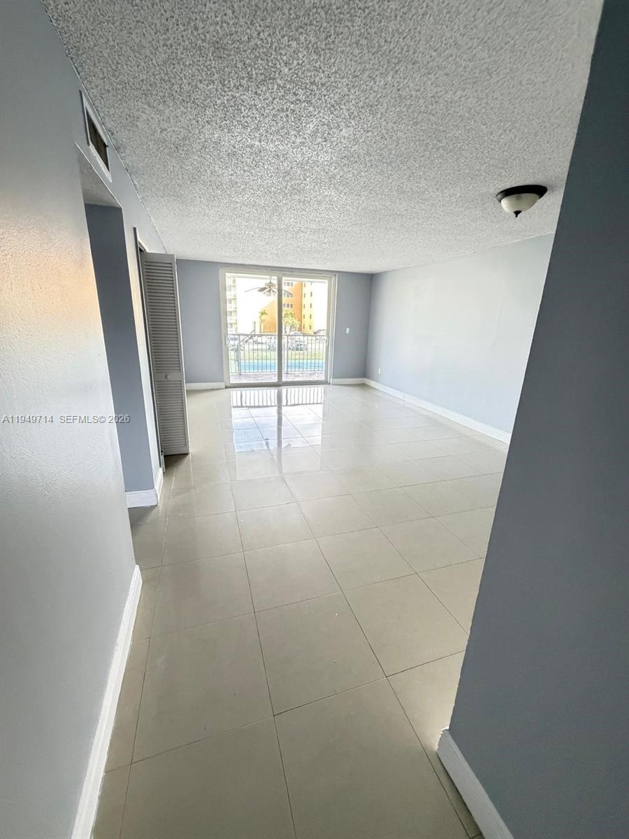 7010 Northwest 186th Street, Unit 5201 Hialeah, FL 33015 - Photo 12 of 29 wooden floor in an empty room with a window