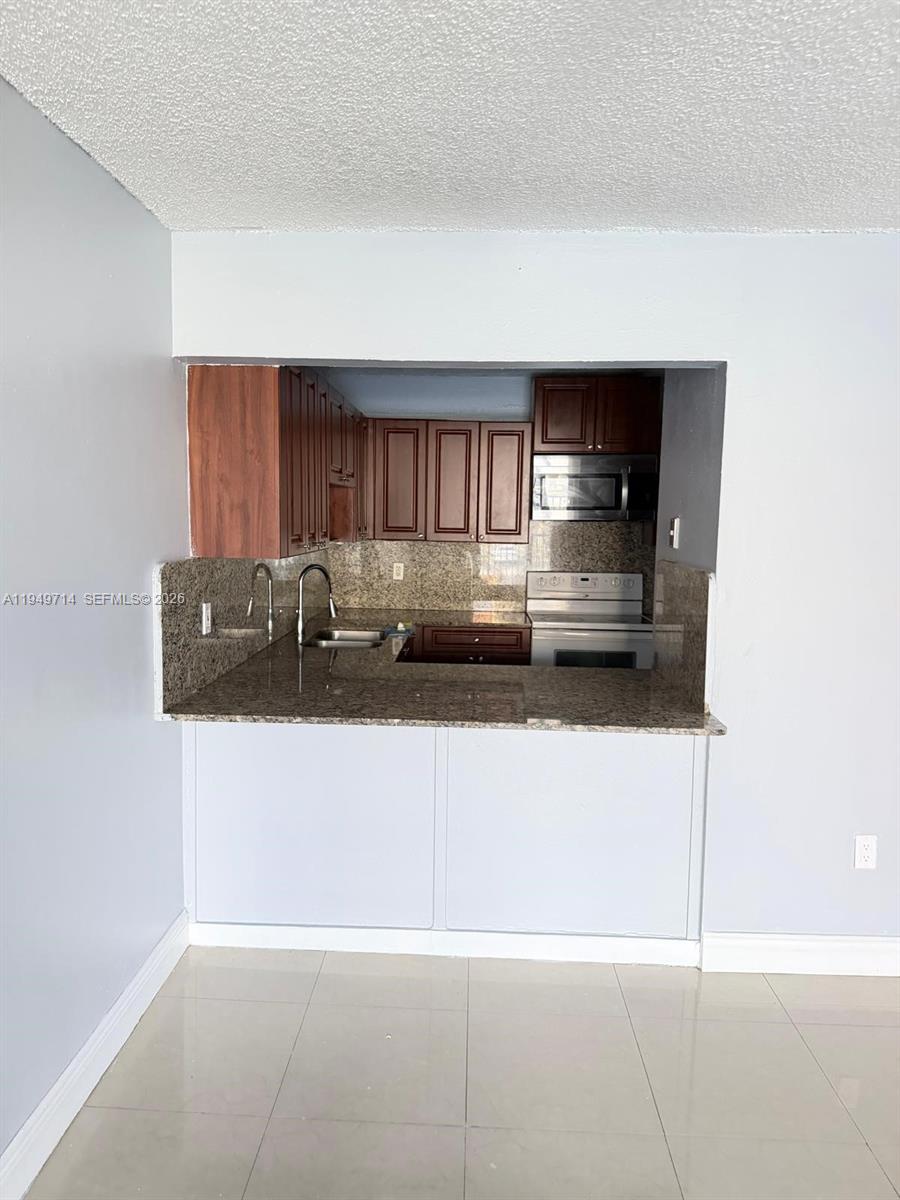 7010 Northwest 186th Street, Unit 5201 Hialeah, FL 33015 - Photo 13 of 29 a view of kitchen island with cabinets