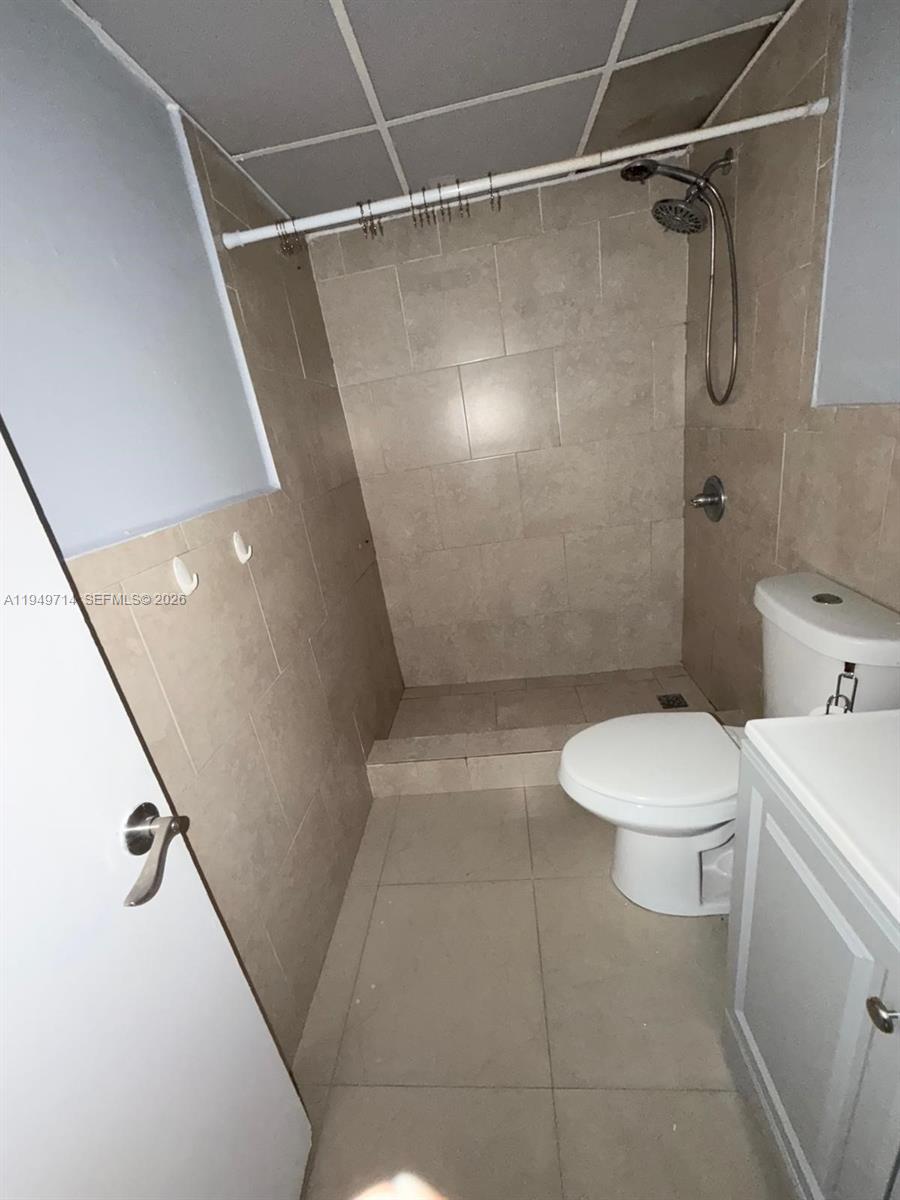 7010 Northwest 186th Street, Unit 5201 Hialeah, FL 33015 - Photo 18 of 29 a bathroom with a toilet a sink and shower