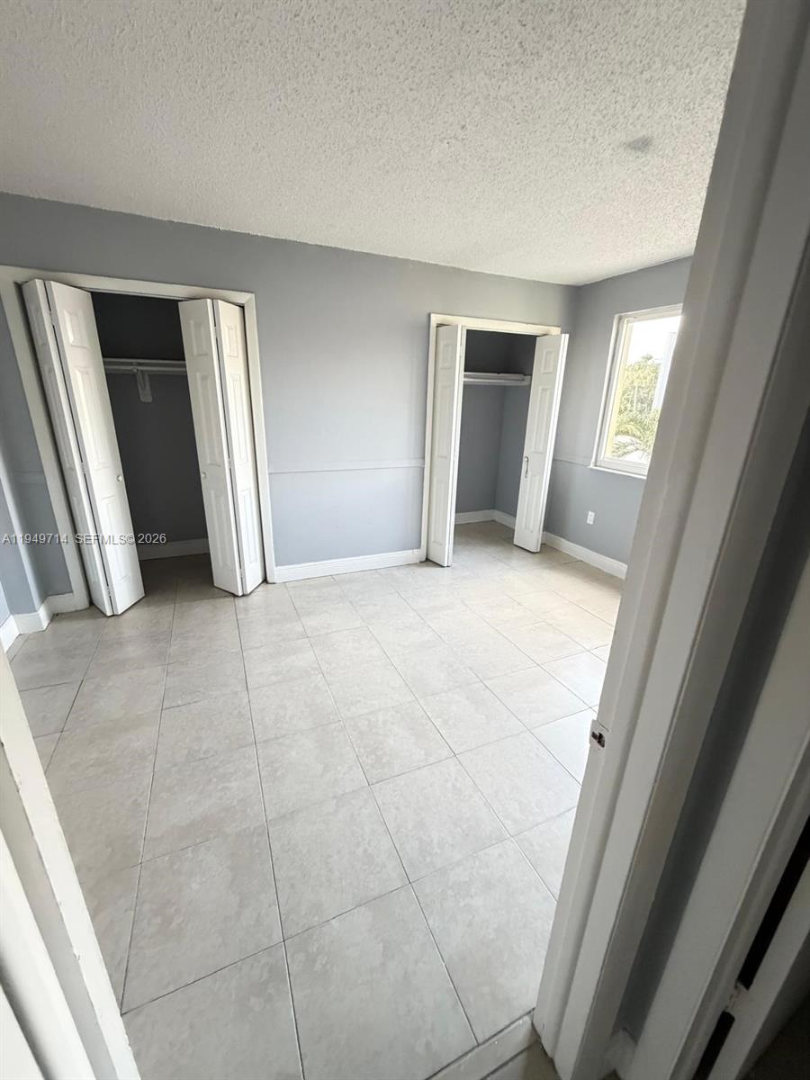 7010 Northwest 186th Street, Unit 5201 Hialeah, FL 33015 - Photo 22 of 29 a view of an empty room and a gallery