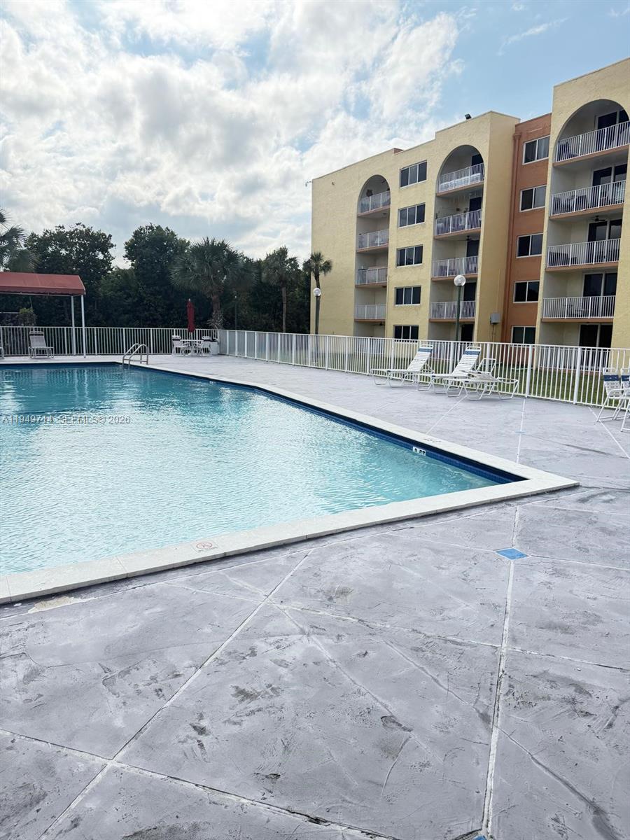 7010 Northwest 186th Street, Unit 5201 Hialeah, FL 33015 - Photo 27 of 29 a view of a swimming pool with a lake view