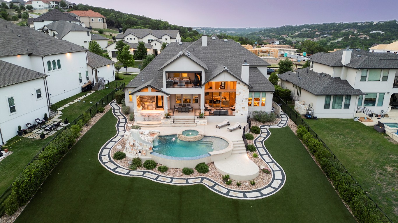 This home offers an extraordinary living experience inside and out, complete with year-round green turf.