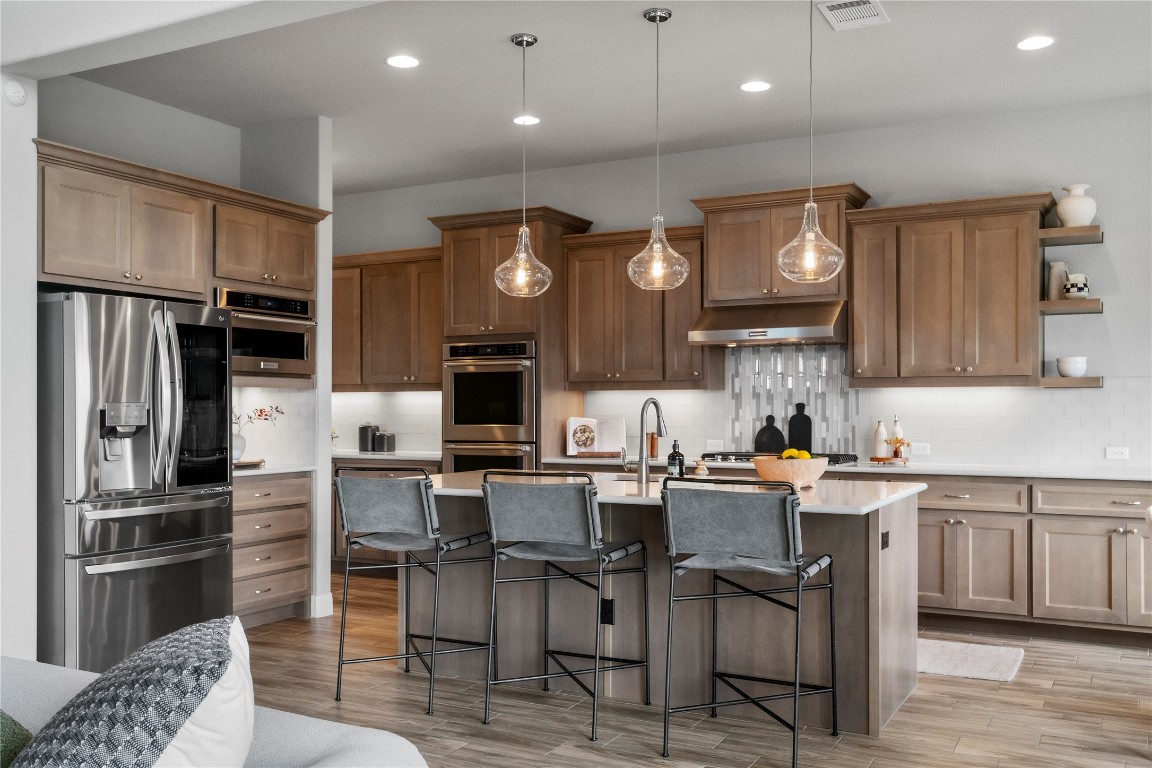 2033 Portobello Road Leander, TX 78641 - Photo 16 of 40 At the heart of the home, the gourmet kitchen features a high-end design.