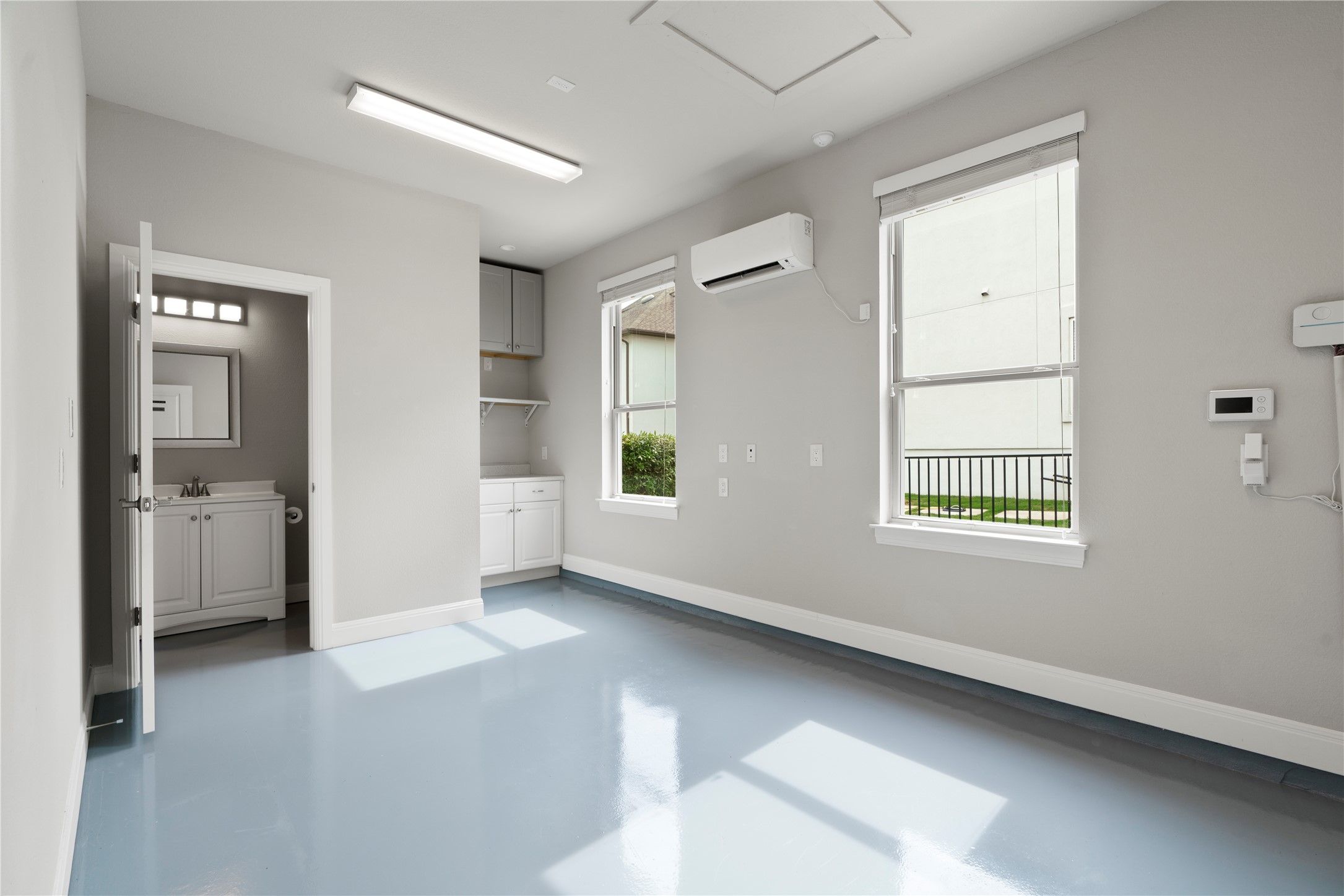 2033 Portobello Road Leander, TX 78641 - Photo 33 of 39 The 4th garage space has been converted into a second office with A/C, a half bath, and a kitchenette.