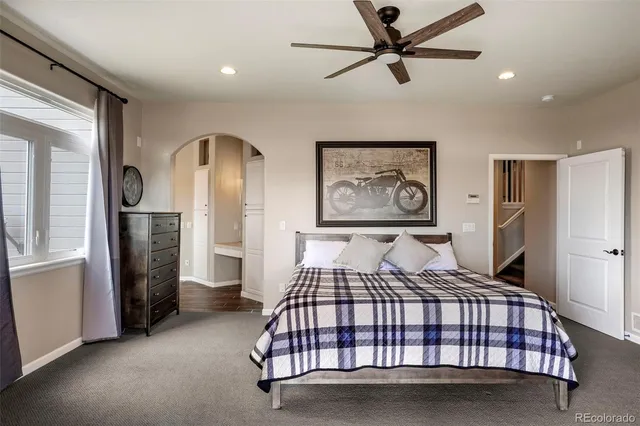 a bedroom with a large bed and a chandelier