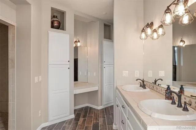 a bathroom with a sink vanity and a mirror