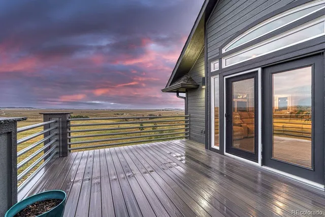 a view of outdoor space with wooden floor and a city view