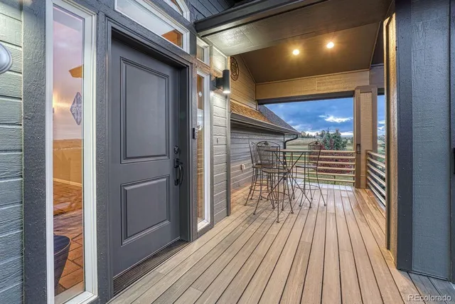 a living room with furniture a fireplace and a floor to ceiling window
