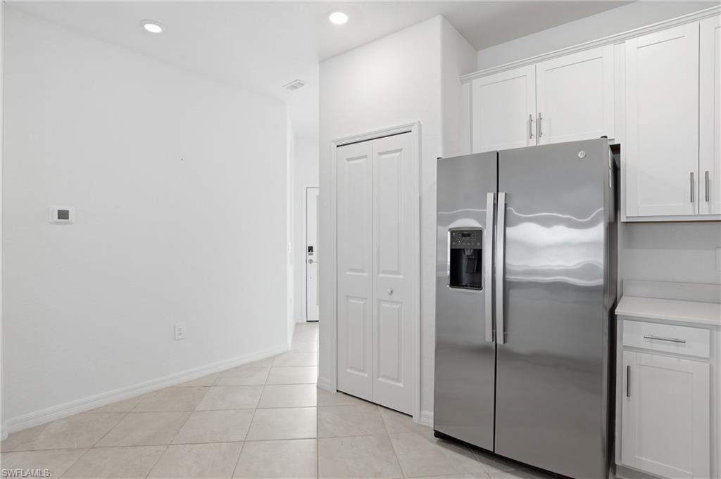 2215 Dragonfruit Way Naples, FL 34120 - Photo 16 of 38 a bathroom with a refrigerator and mirror