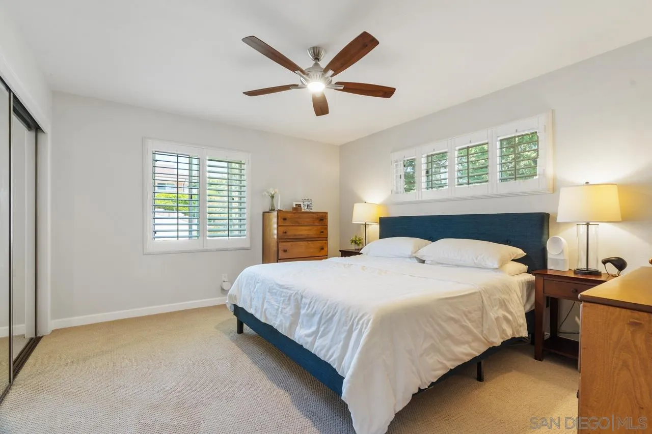 6365 Lambda Drive San Diego, CA 92120 - Photo 13 of 31 a bedroom with a bed next to a window with a chandelier