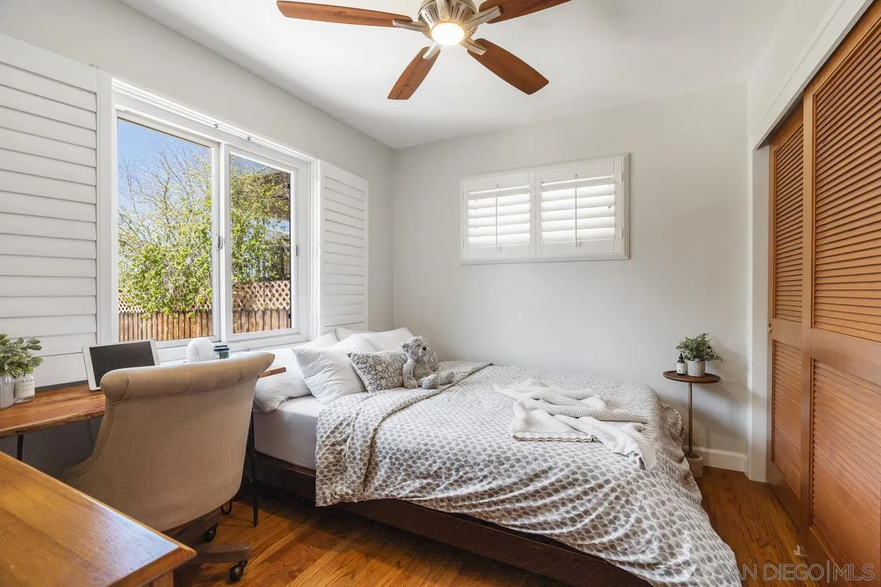 6365 Lambda Drive San Diego, CA 92120 - Photo 19 of 31 a bedroom with a bed and wooden floor