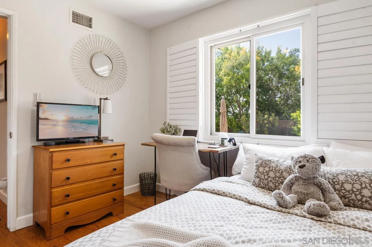 6365 Lambda Drive San Diego, CA 92120 - Photo 20 of 31 a bedroom with a bed and a flat screen tv