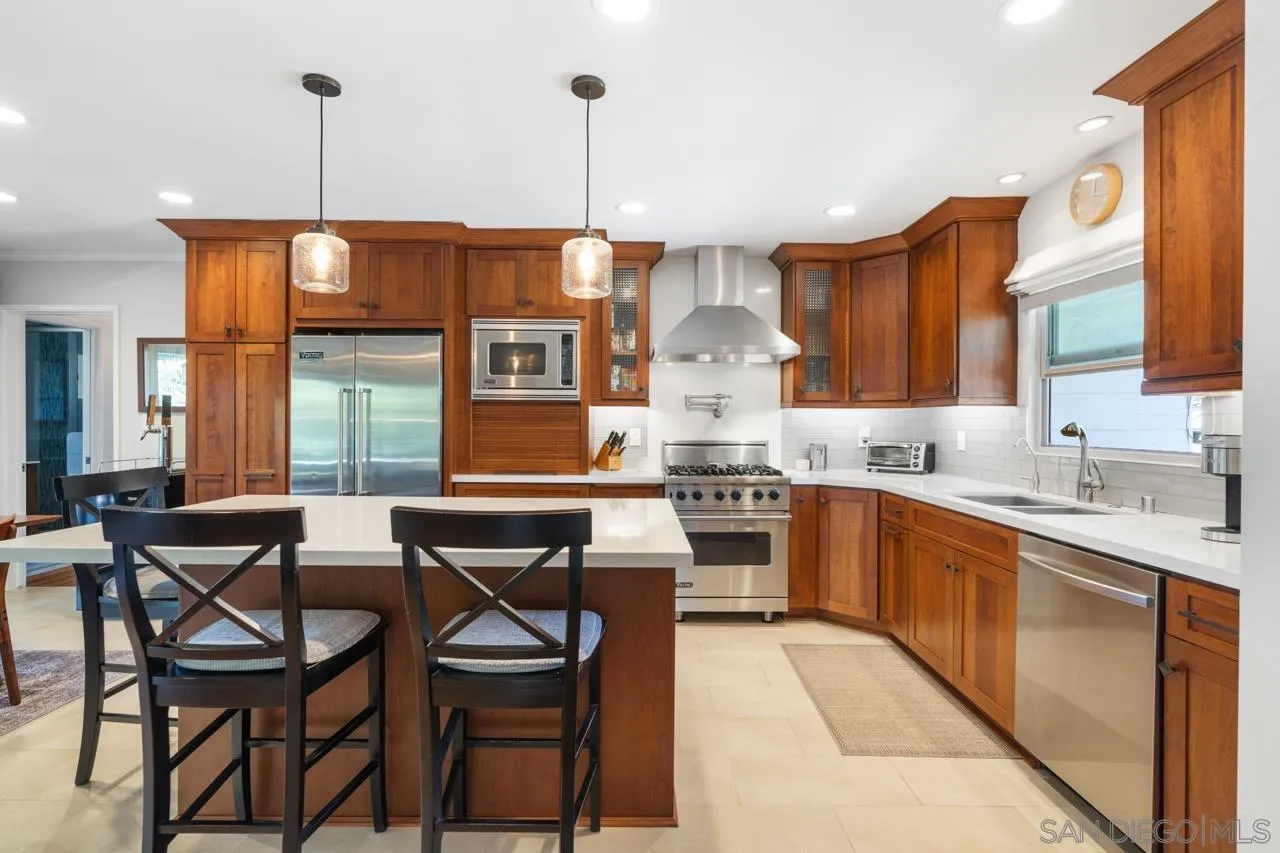6365 Lambda Drive San Diego, CA 92120 - Photo 2 of 31 a kitchen with stainless steel appliances granite countertop a sink a stove and chairs