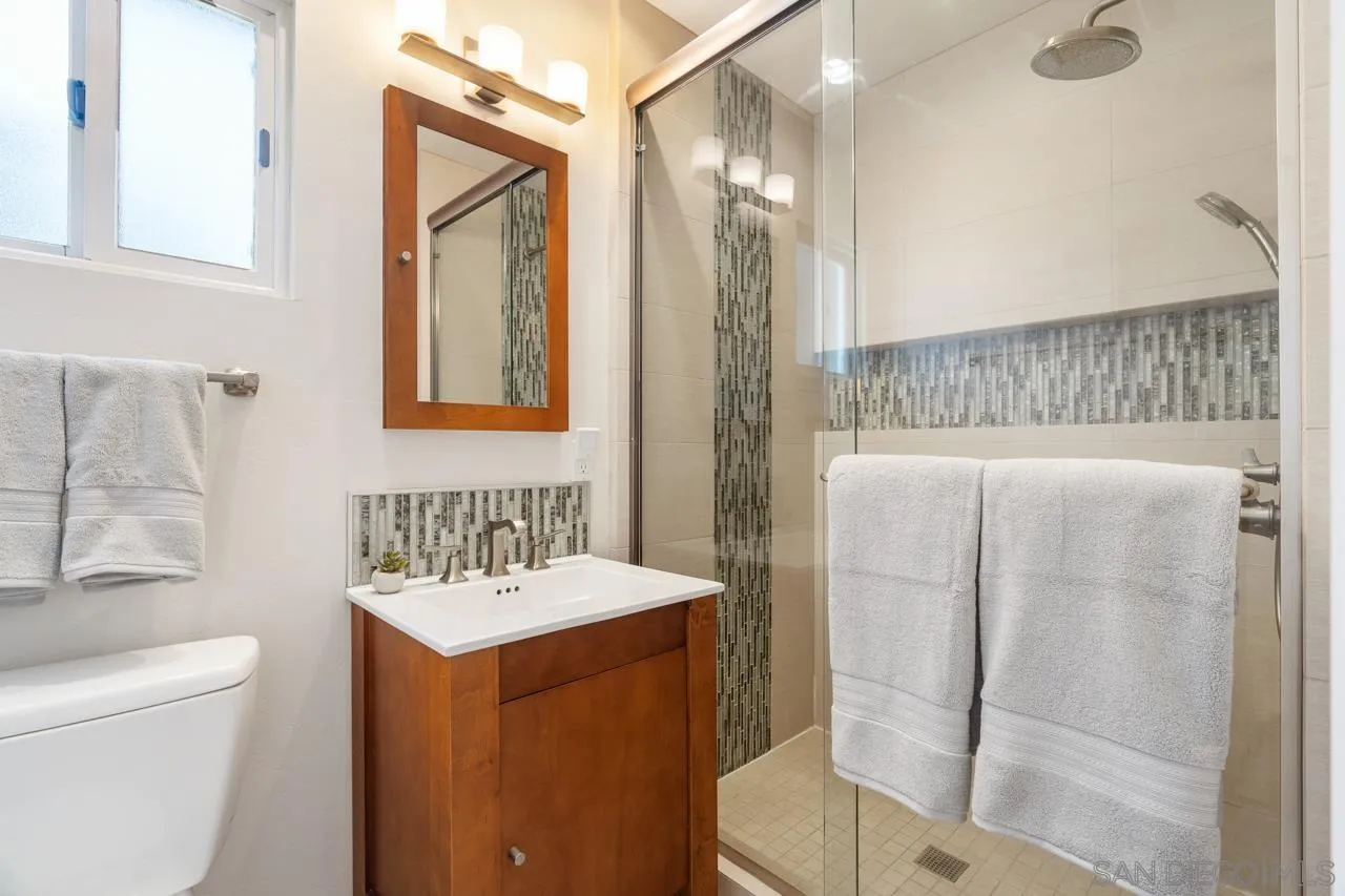 6365 Lambda Drive San Diego, CA 92120 - Photo 21 of 31 a bathroom with a sink toilet and shower