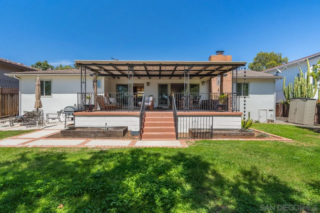 6365 Lambda Drive San Diego, CA 92120 - Photo 25 of 31 a view of a house with a patio and a yard