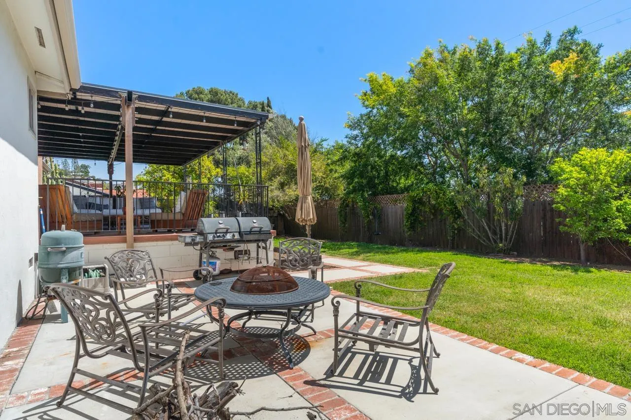 6365 Lambda Drive San Diego, CA 92120 - Photo 26 of 31 a view of patio with table and chairs and potted plants with wooden fence