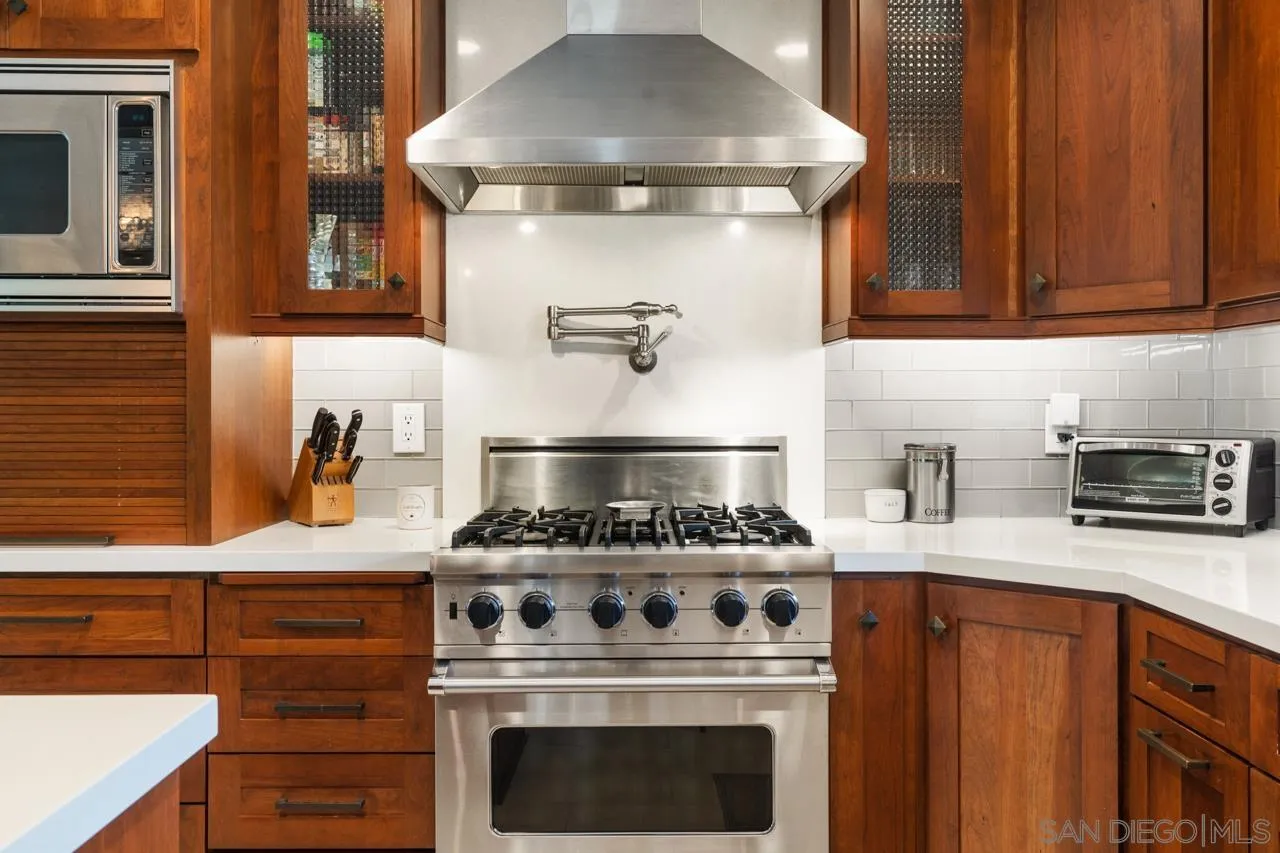 6365 Lambda Drive San Diego, CA 92120 - Photo 3 of 31 a kitchen with stainless steel appliances granite countertop a stove and a microwave