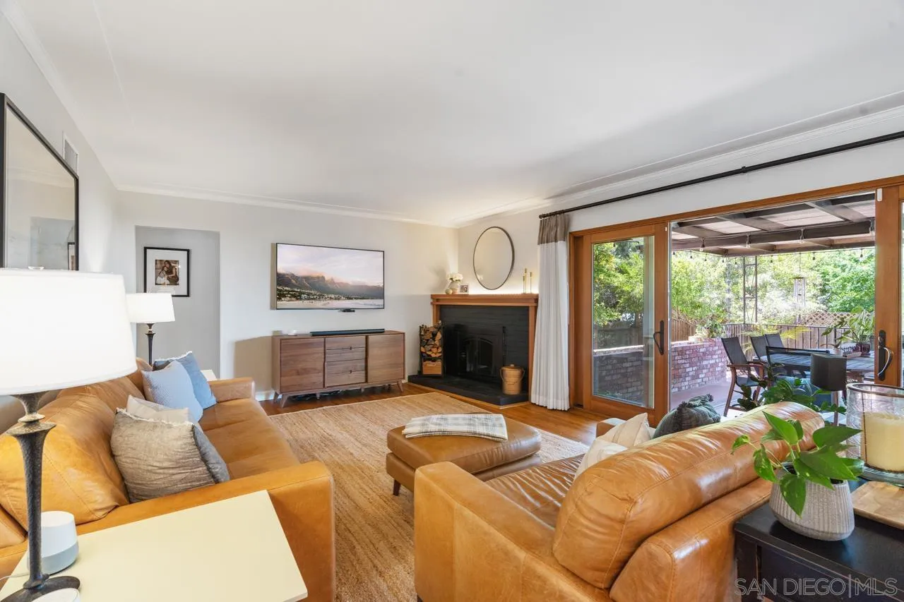 6365 Lambda Drive San Diego, CA 92120 - Photo 6 of 31 a living room with furniture a large window and a fireplace
