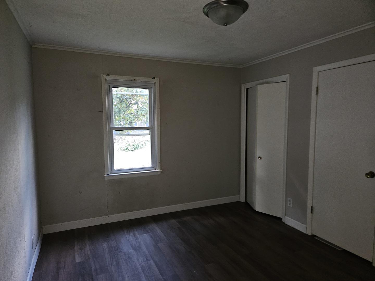 621 North 7th Street Herrin, IL 62948 - Photo 11 of 19 an empty room with wooden floor cabinet and windows